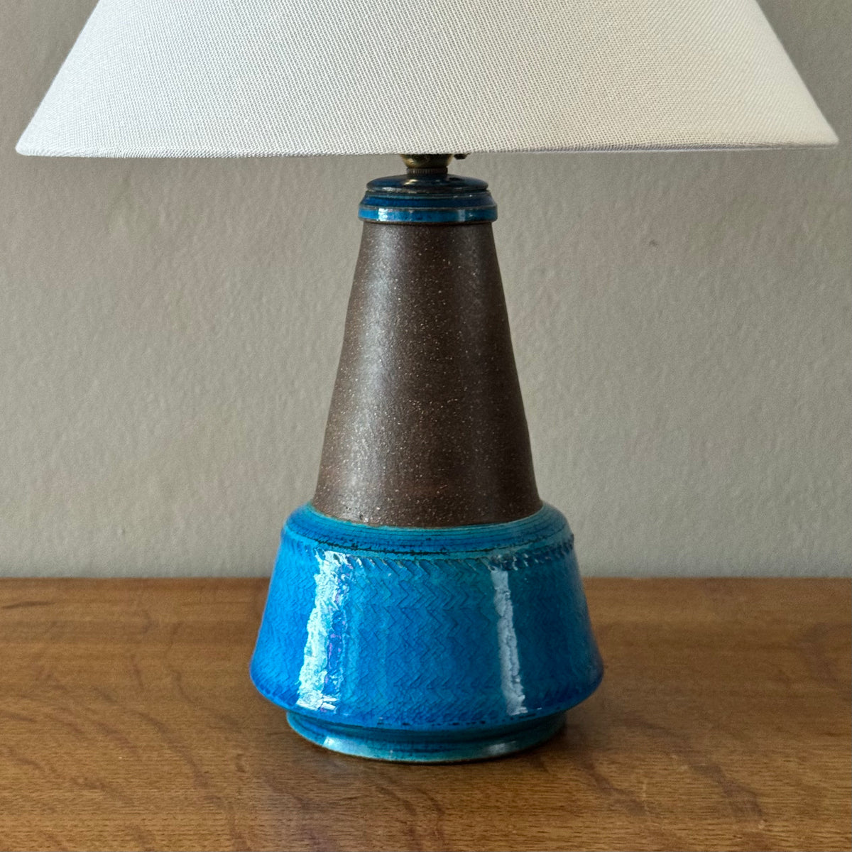 Blue stoneware table lamp from Denmark, by Herman A. Kähler and Nils Kähler. This Danish ceramic piece combines sculptural form and warm glaze tones, representative of mid-century Scandinavian lighting design.