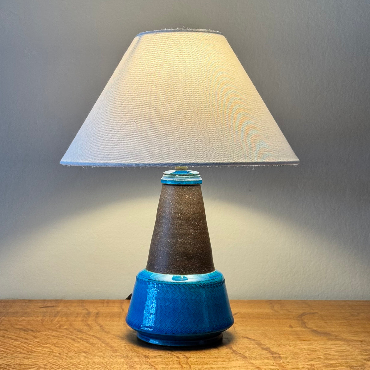 Blue stoneware table lamp from Denmark, by Herman A. Kähler and Nils Kähler. This Danish ceramic piece combines sculptural form and warm glaze tones, representative of mid-century Scandinavian lighting design.