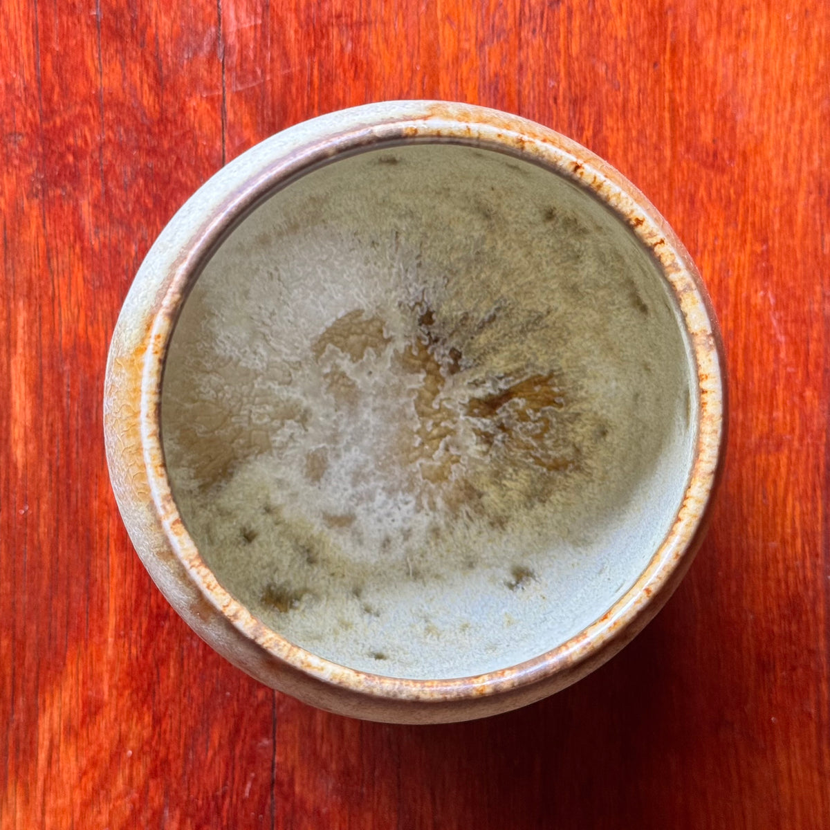 A handcrafted ceramic cup by Kasper Würtz, a Danish ceramicist renowned for his hand-thrown and hand-glazed stoneware. Inspired by Nordic utilitarian crafts and British studio pottery, the design features a balanced inner-outer ratio, subtle concavity, and a glaze that harmoniously blends matte and glossy finishes. Diameter: 7.5 cm, Height: 7.5 cm.
