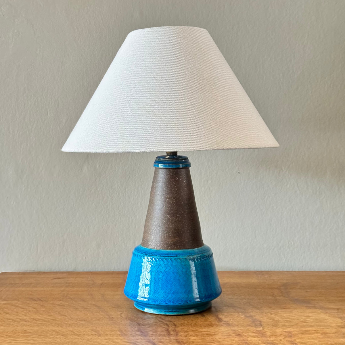 Blue stoneware table lamp from Denmark, by Herman A. Kähler and Nils Kähler. This Danish ceramic piece combines sculptural form and warm glaze tones, representative of mid-century Scandinavian lighting design.