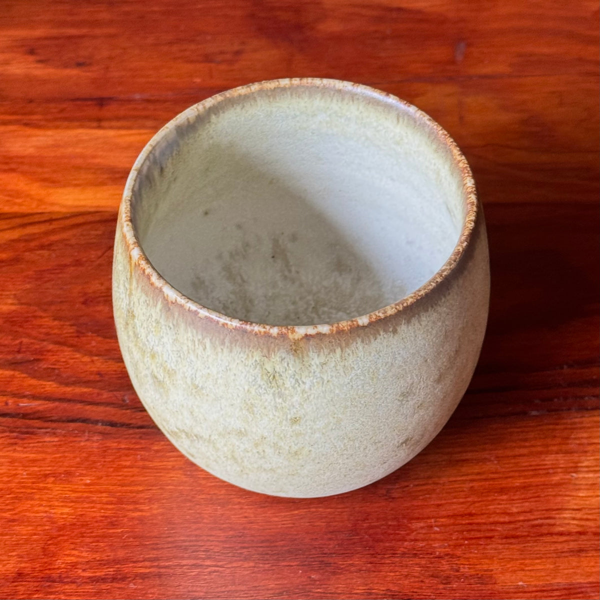 A handcrafted ceramic cup by Kasper Würtz, a Danish ceramicist renowned for his hand-thrown and hand-glazed stoneware. Inspired by Nordic utilitarian crafts and British studio pottery, the design features a balanced inner-outer ratio, subtle concavity, and a glaze that harmoniously blends matte and glossy finishes. Diameter: 7.5 cm, Height: 7.5 cm.