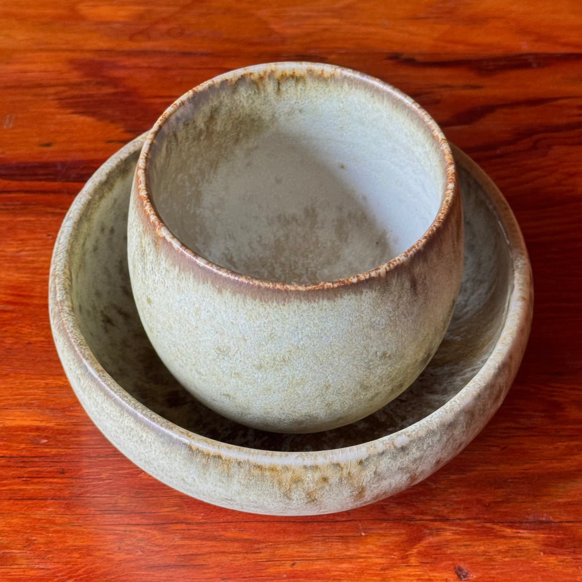 A handcrafted ceramic cup by Kasper Würtz, a Danish ceramicist renowned for his hand-thrown and hand-glazed stoneware. Inspired by Nordic utilitarian crafts and British studio pottery, the design features a balanced inner-outer ratio, subtle concavity, and a glaze that harmoniously blends matte and glossy finishes. Diameter: 7.5 cm, Height: 7.5 cm.