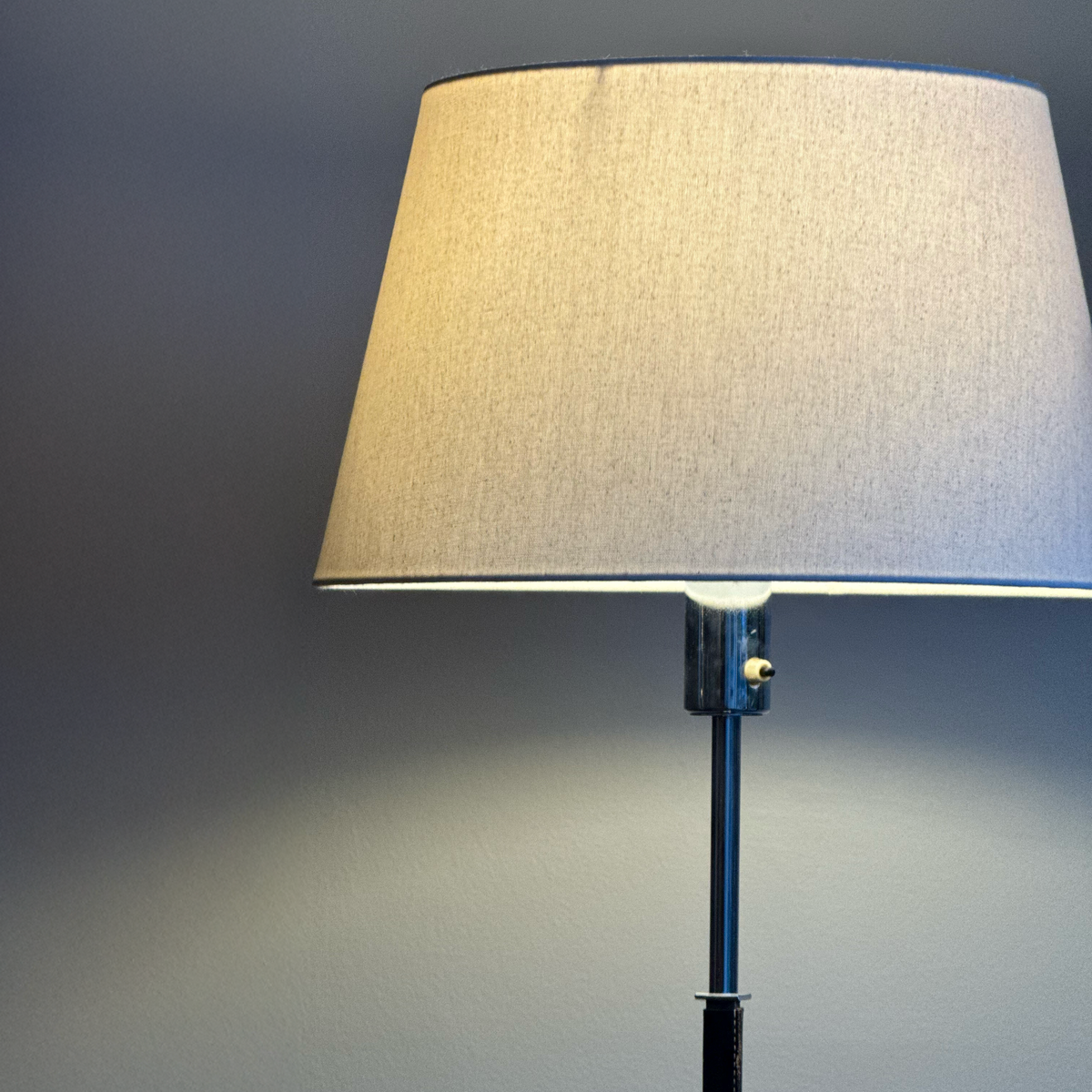 A vintage 1960s full-length floor lamp by Philips Netherlands, featuring a sleek steel frame complemented by leather accents. This mid-century modern design combines industrial materials with refined craftsmanship, offering both style and functionality.