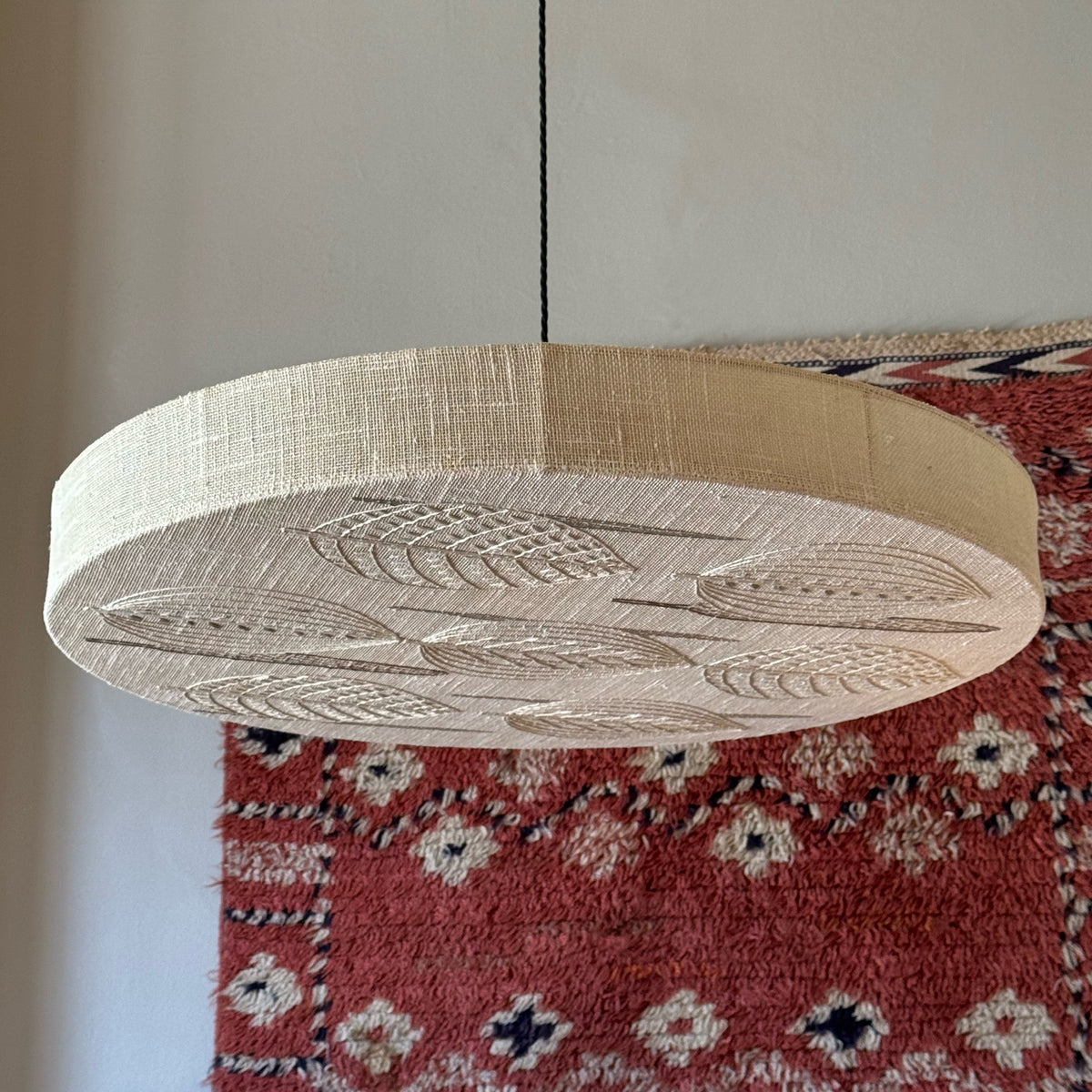 Sigmar London. Designed in the 1970s, the lamp emits a soft, diffused light through delicate stitched patterns, blending textile craftsmanship with functional lighting, from Sweden.