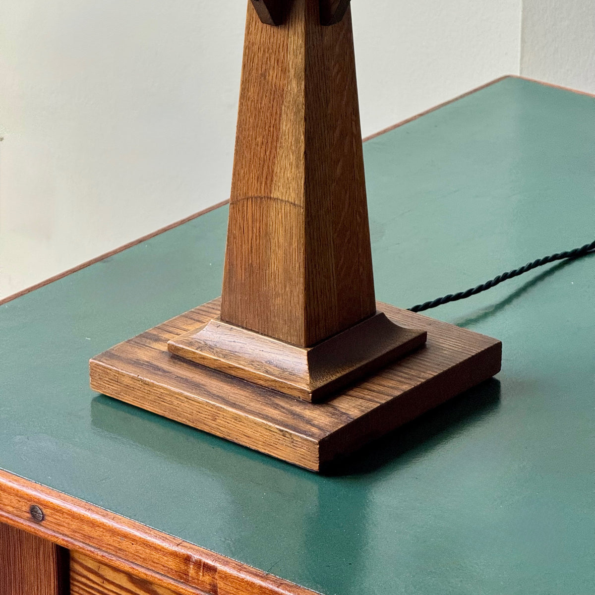 Wooden lamp base on a green surface