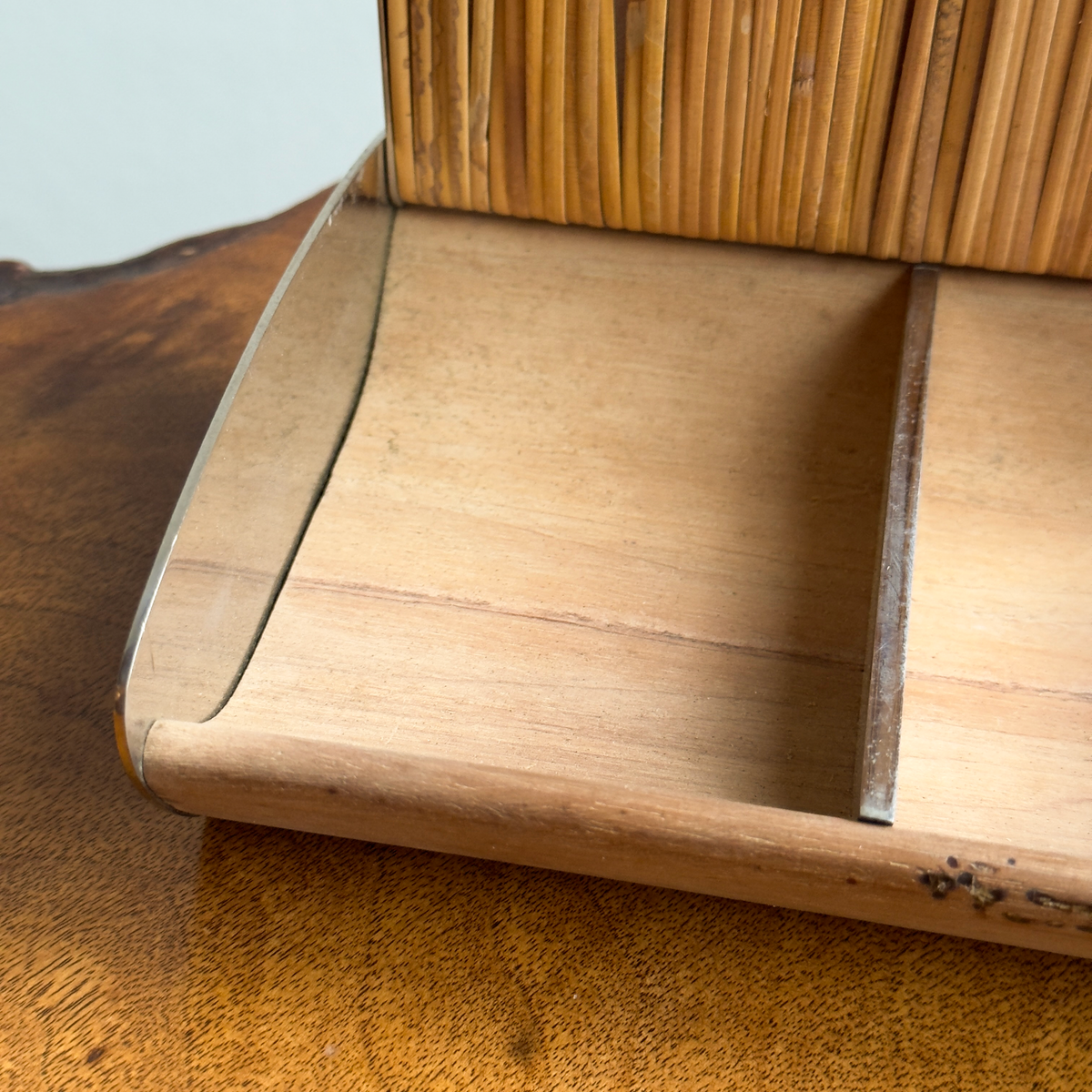 A vintage 1950s cigarette box by Carl Auböck, featuring a walnut body with chrome-plated brass ends. This original piece exemplifies mid-century Austrian design and craftsmanship.