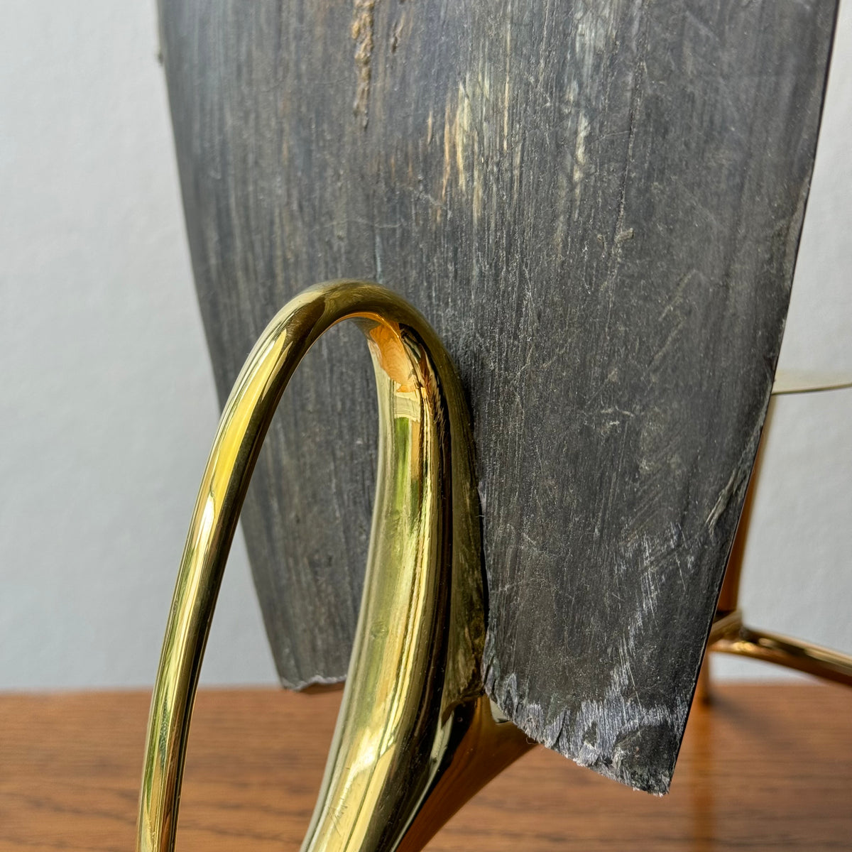 A cast brass horn candle holder and lantern sconce designed by Carl Auböck, made in Austria. This piece combines functionality with elegant, modernist design.