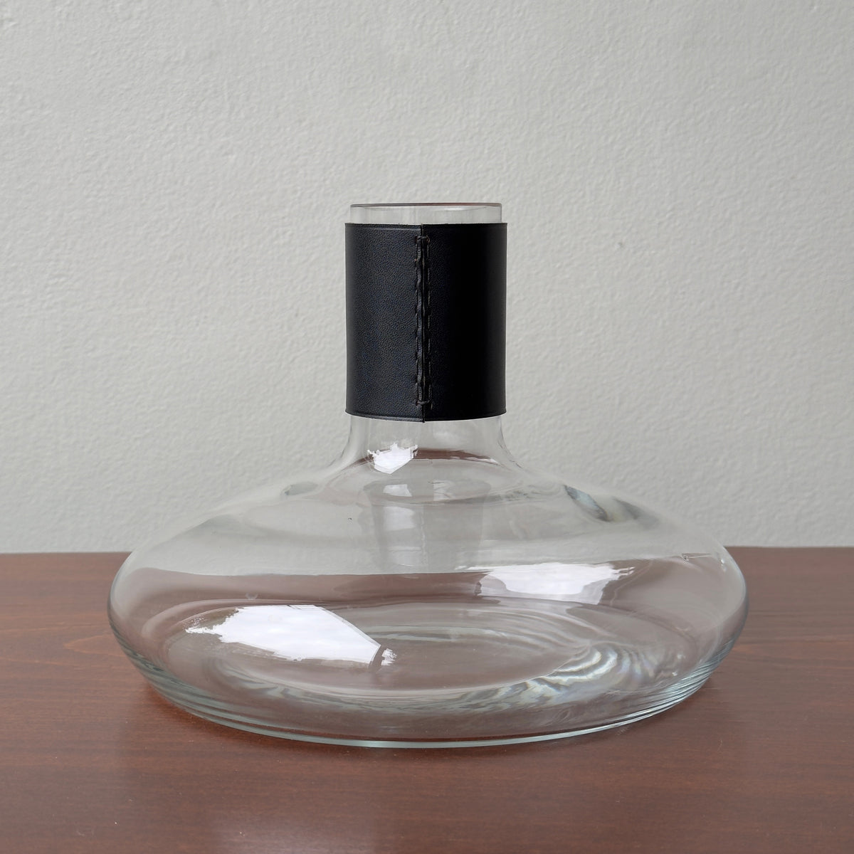 A vintage Carl Auböck vase with leather collar designed by Carl Auböck II. This vase is hand-blown and testament to the craftsmanship of this prestigious Austrian workshop. 