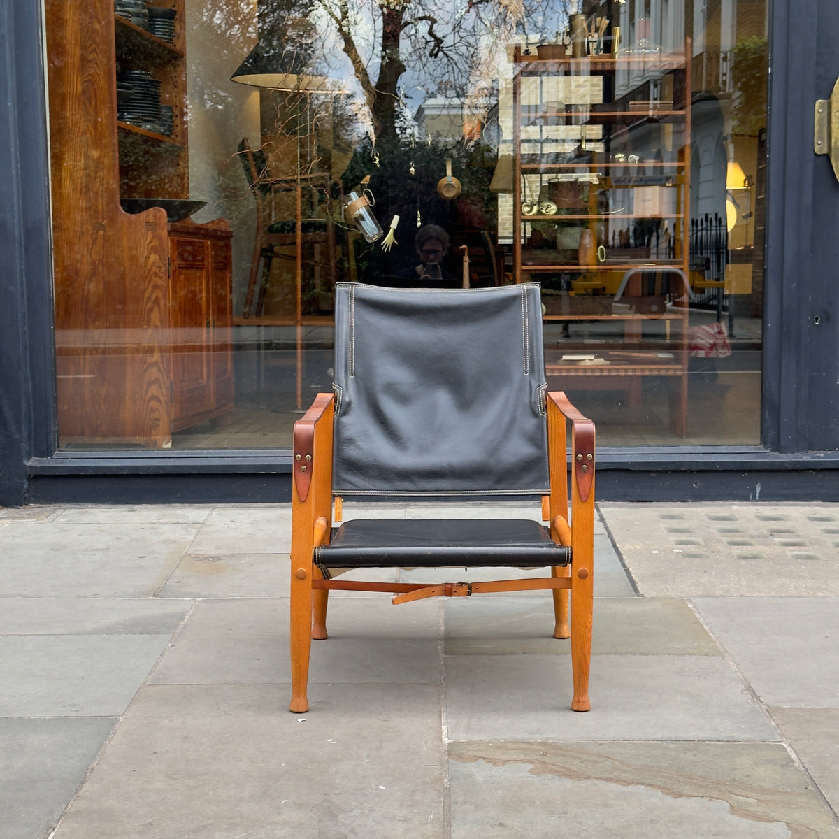 A Kaare Klint black leather safari chair, originally designed in the 1930s with this example produced in the 1950s. This original vintage piece, available at Sigmar, reflects Klint's pioneering approach to functional yet elegant Danish modern design