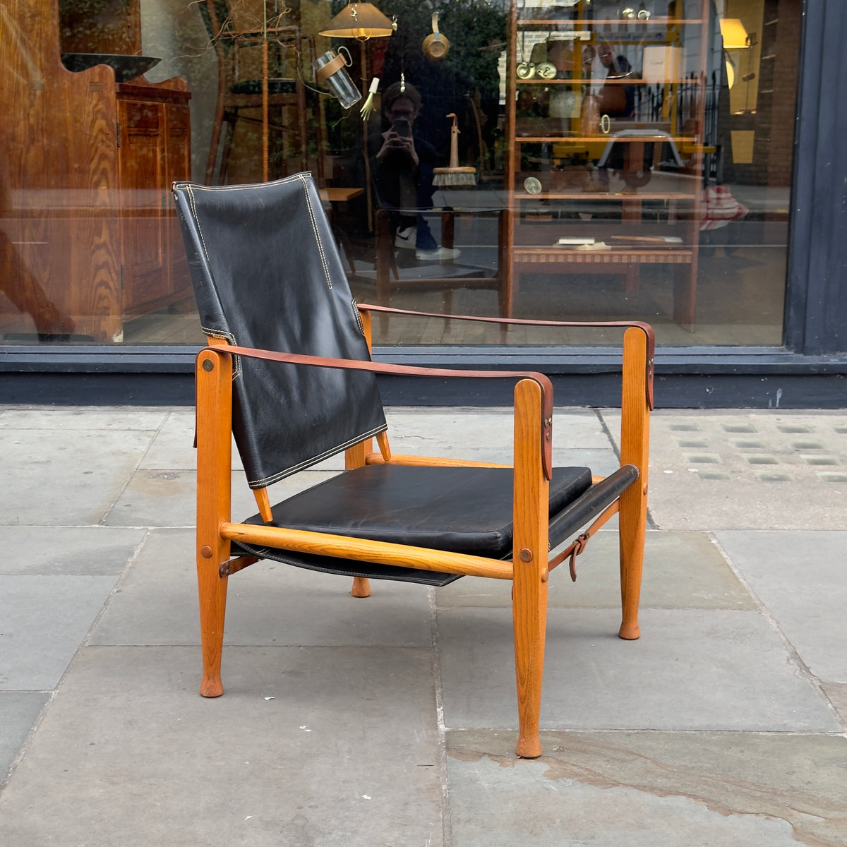 A Kaare Klint black leather safari chair, originally designed in the 1930s with this example produced in the 1950s. This original vintage piece, available at Sigmar, reflects Klint's pioneering approach to functional yet elegant Danish modern design