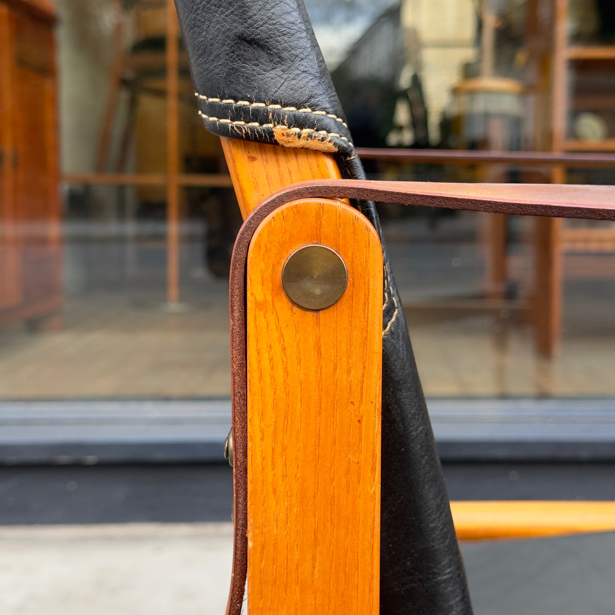 A Kaare Klint black leather safari chair, originally designed in the 1930s with this example produced in the 1950s. This original vintage piece, available at Sigmar, reflects Klint's pioneering approach to functional yet elegant Danish modern design