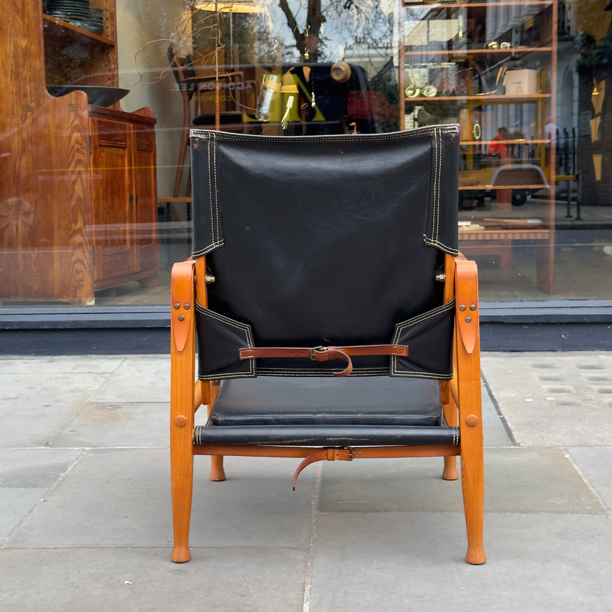 A Kaare Klint black leather safari chair, originally designed in the 1930s with this example produced in the 1950s. This original vintage piece, available at Sigmar, reflects Klint's pioneering approach to functional yet elegant Danish modern design