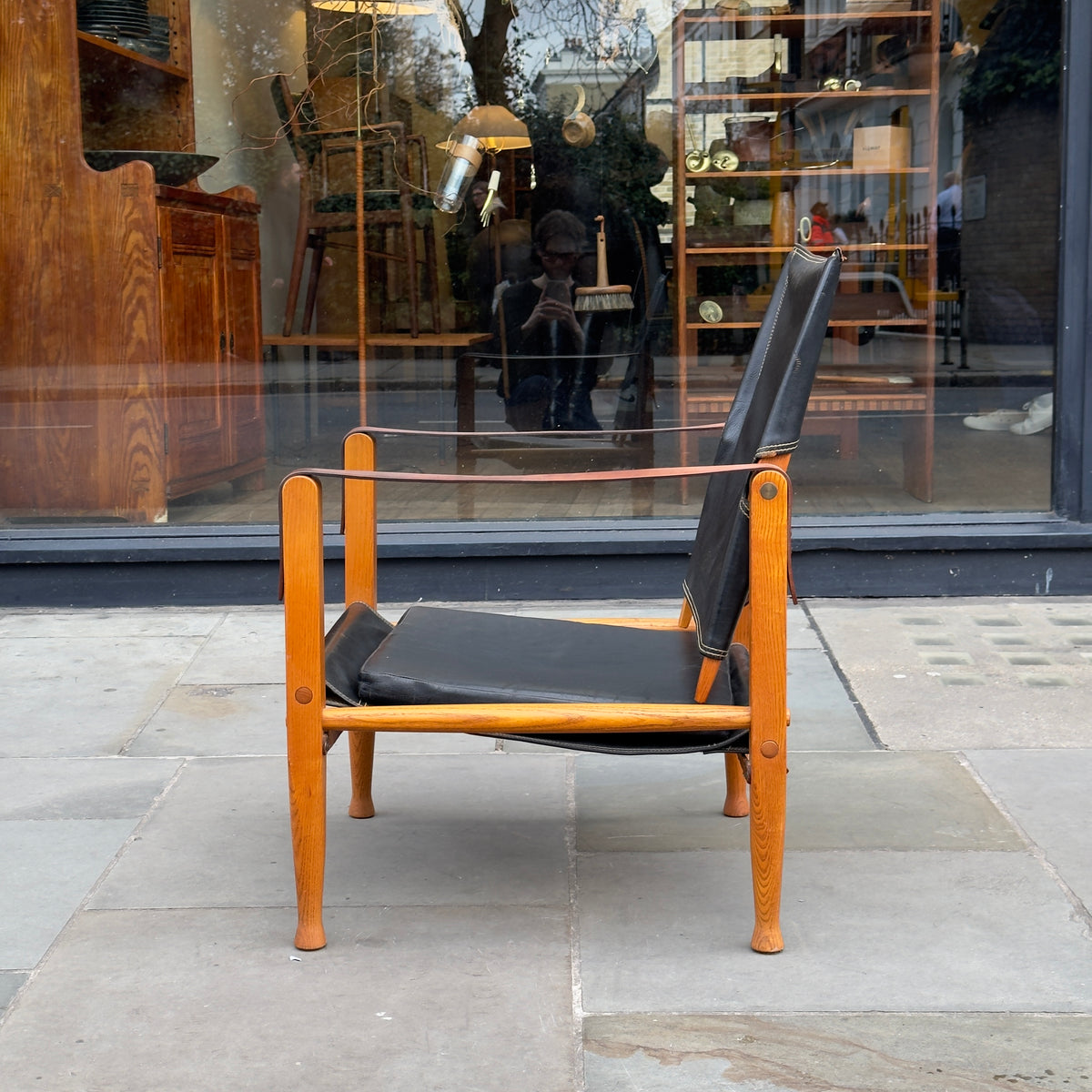A Kaare Klint black leather safari chair, originally designed in the 1930s with this example produced in the 1950s. This original vintage piece, available at Sigmar, reflects Klint's pioneering approach to functional yet elegant Danish modern design