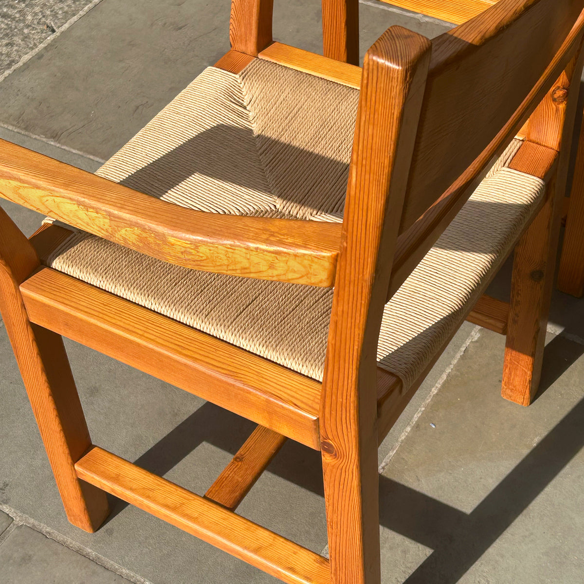 A set of 6 danish pine dining chairs with paper cord seats, pictured outside antiques dealership, Sigmar. 