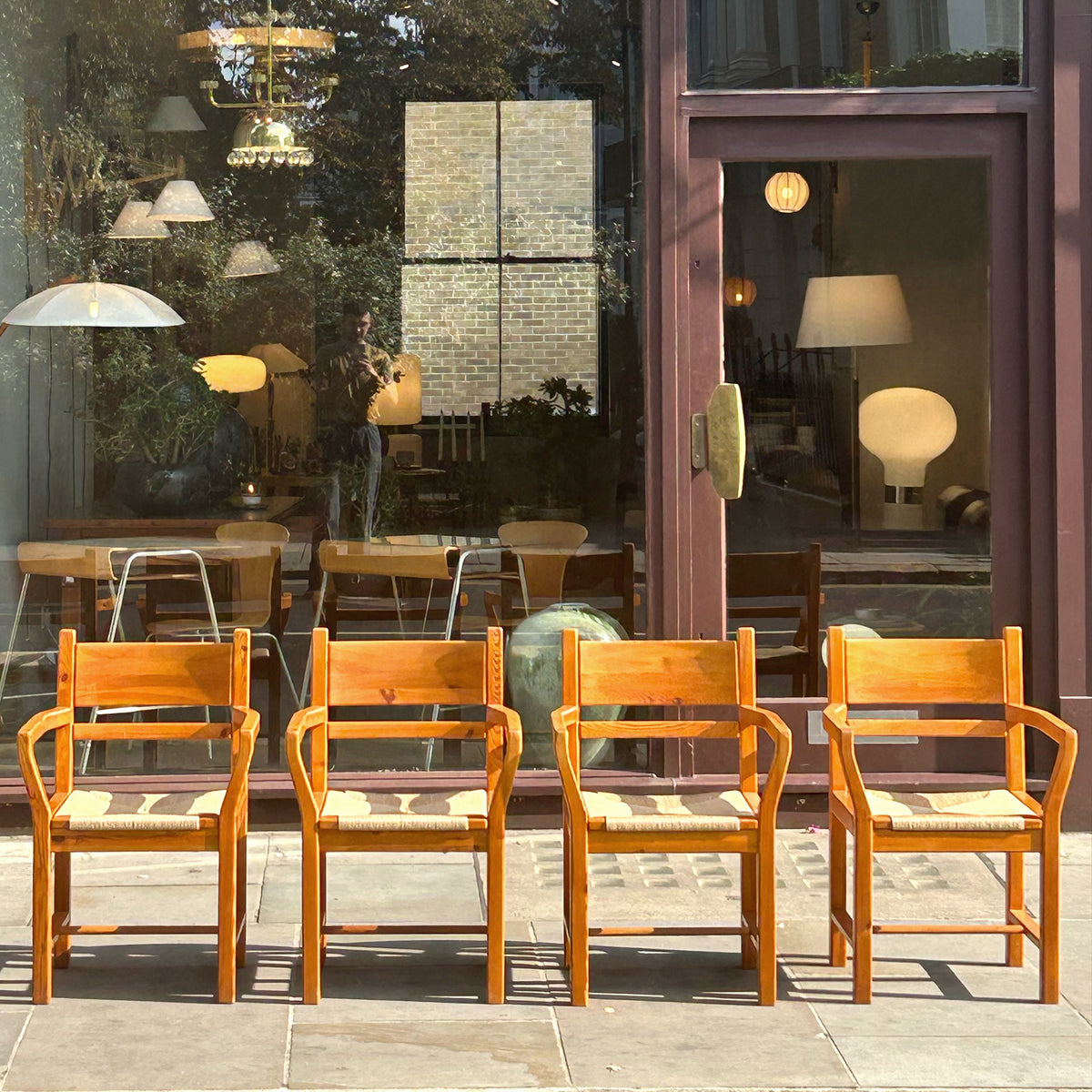 A set of 6 danish pine dining chairs with paper cord seats, pictured outside antiques dealership, Sigmar. 