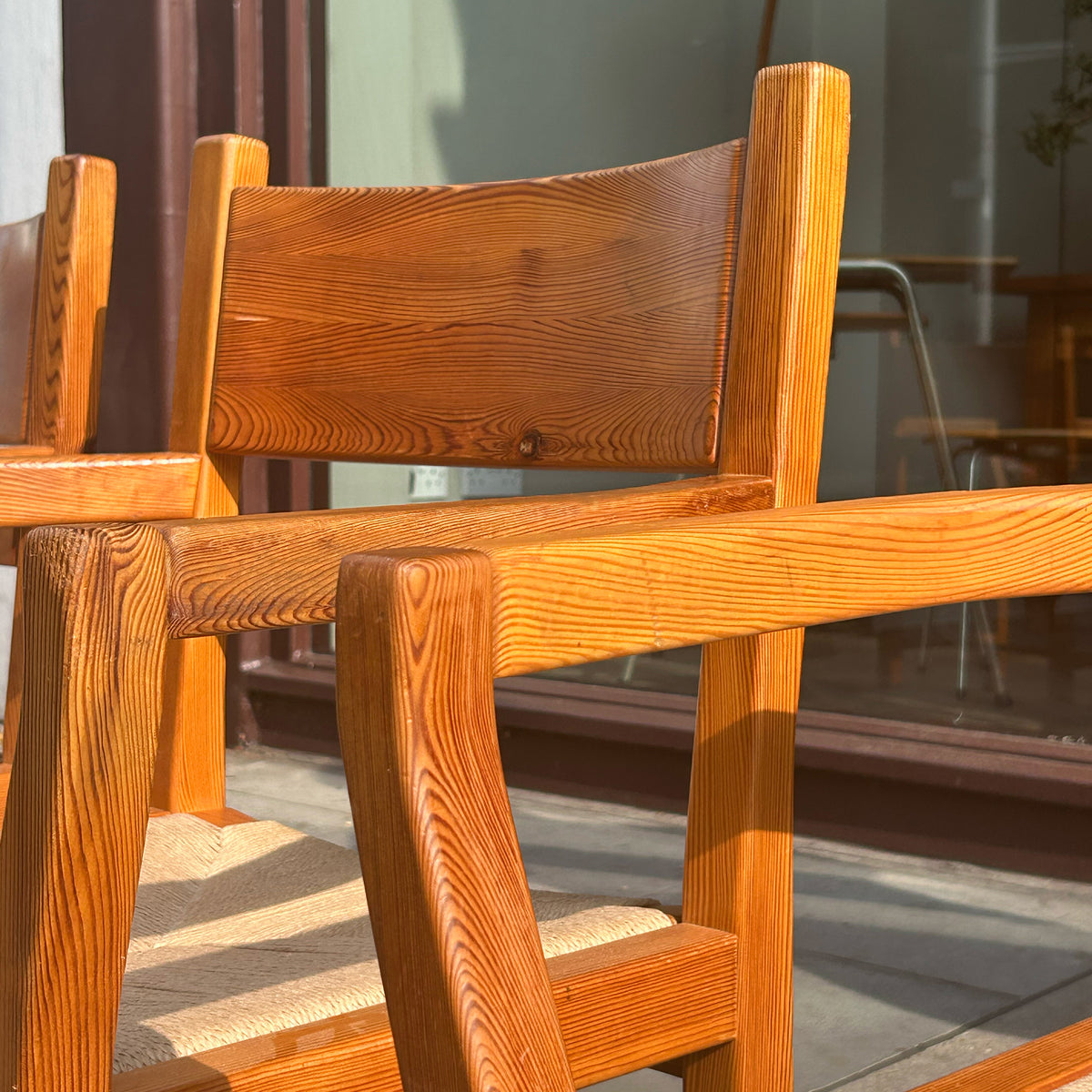 A set of 6 danish pine dining chairs with paper cord seats, pictured outside antiques dealership, Sigmar. 