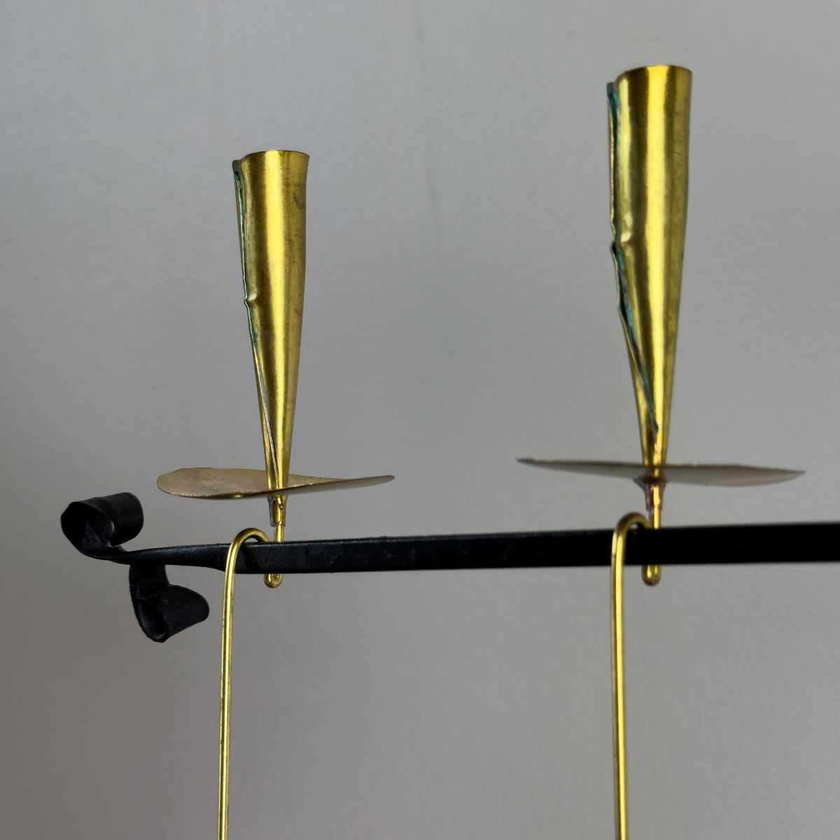 A kinetic candelabrum designed by Thomas Hellström in the 1950s, crafted in Sweden. This unique piece reinterprets Swedish folk aesthetics, blending traditional design elements with a dynamic, mid-century modern twist.