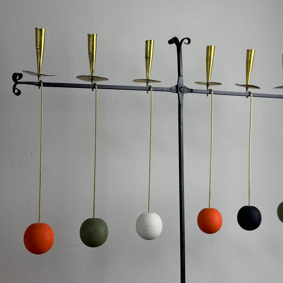 A kinetic candelabrum designed by Thomas Hellström in the 1950s, crafted in Sweden. This unique piece reinterprets Swedish folk aesthetics, blending traditional design elements with a dynamic, mid-century modern twist.