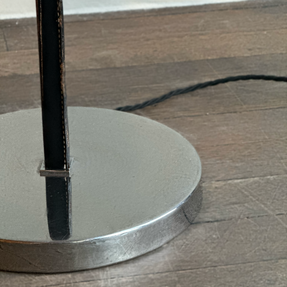 A vintage 1960s full-length floor lamp by Philips Netherlands, featuring a sleek steel frame complemented by leather accents. This mid-century modern design combines industrial materials with refined craftsmanship, offering both style and functionality.