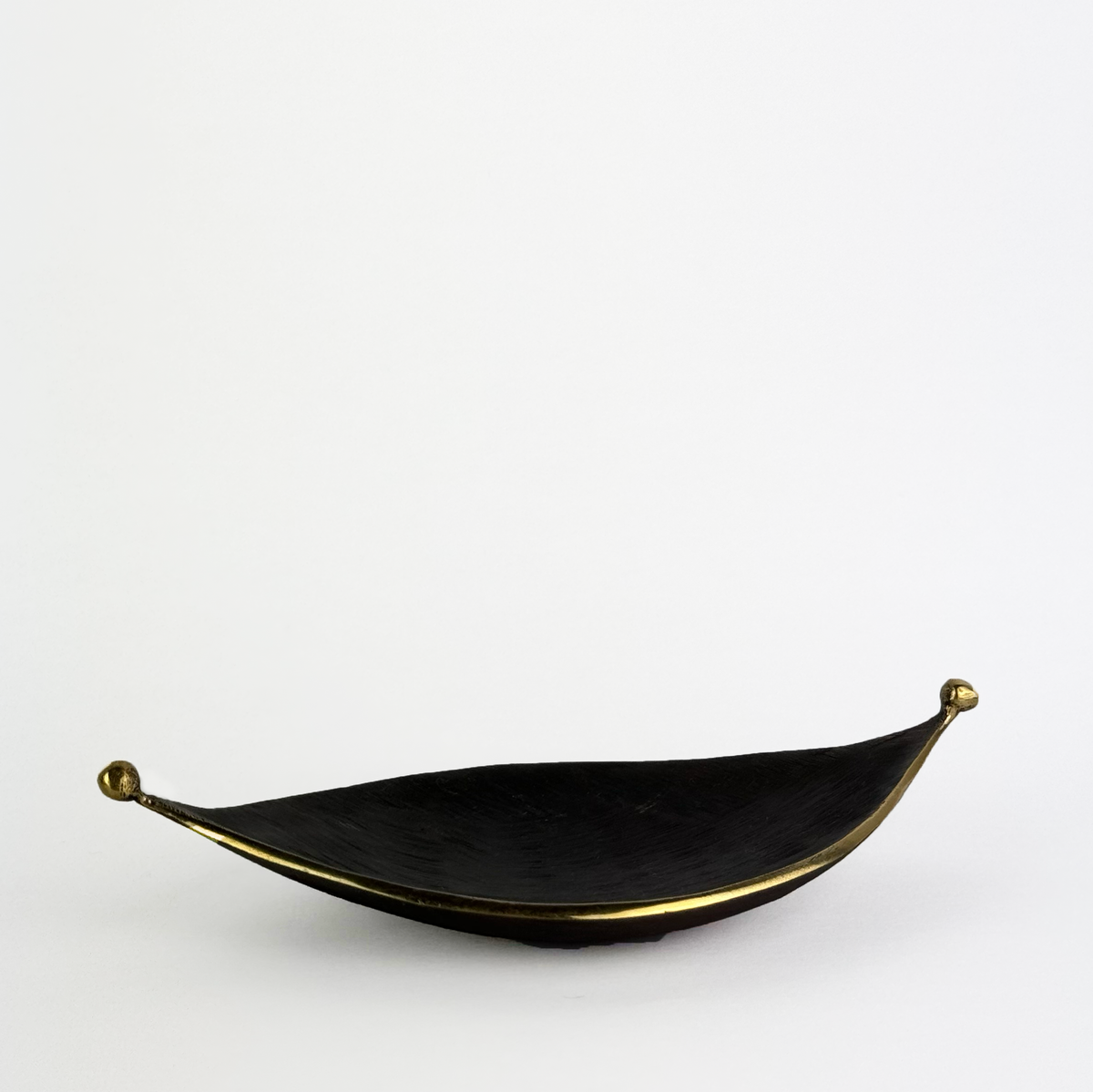 A midcentury leaf tray by Carl Auböck, available at Sigmar London. Crafted in brass with a textured finish, this versatile piece serves as an ashtray or decorative tray, exemplifying modern design and fine Austrian craftsmanship.