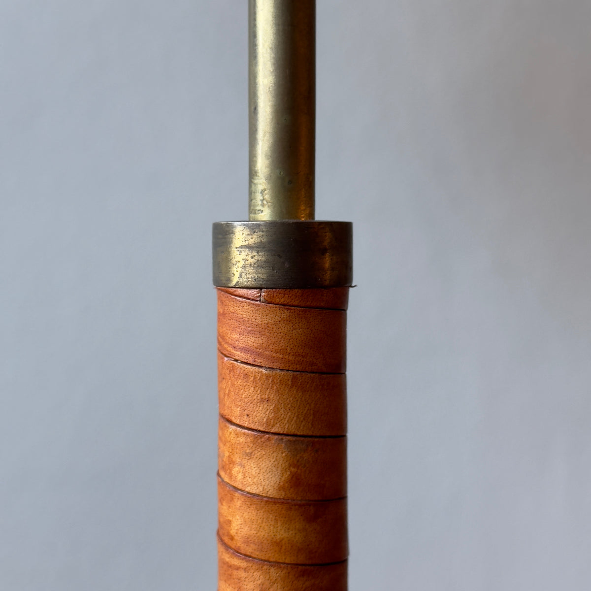 An original vintage leather-bound brass telescopic floor lamp from Denmark. This mid-century piece features an adjustable design with a rich patina, available from Sigmar London.