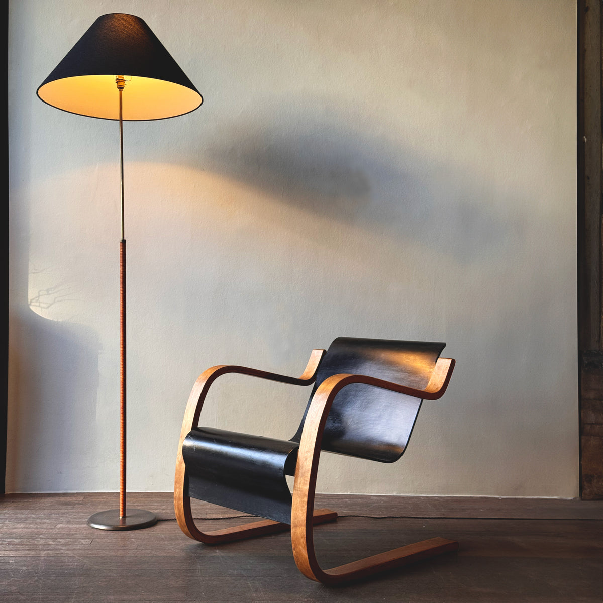 An original vintage leather-bound brass telescopic floor lamp from Denmark. This mid-century piece features an adjustable design with a rich patina, available from Sigmar London."