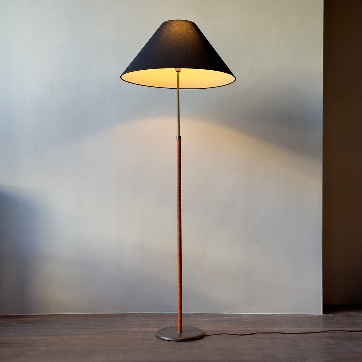 An original vintage leather-bound brass telescopic floor lamp from Denmark. This mid-century piece features an adjustable design with a rich patina, available from Sigmar London.