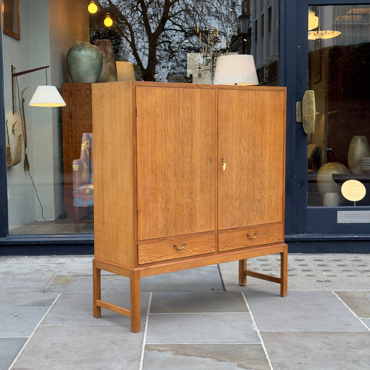 A tall oak cabinet designed by Ole Wanscher and crafted by A.J. Iversen in Denmark. This midcentury piece exemplifies Danish modern design with its refined craftsmanship and timeless elegance.