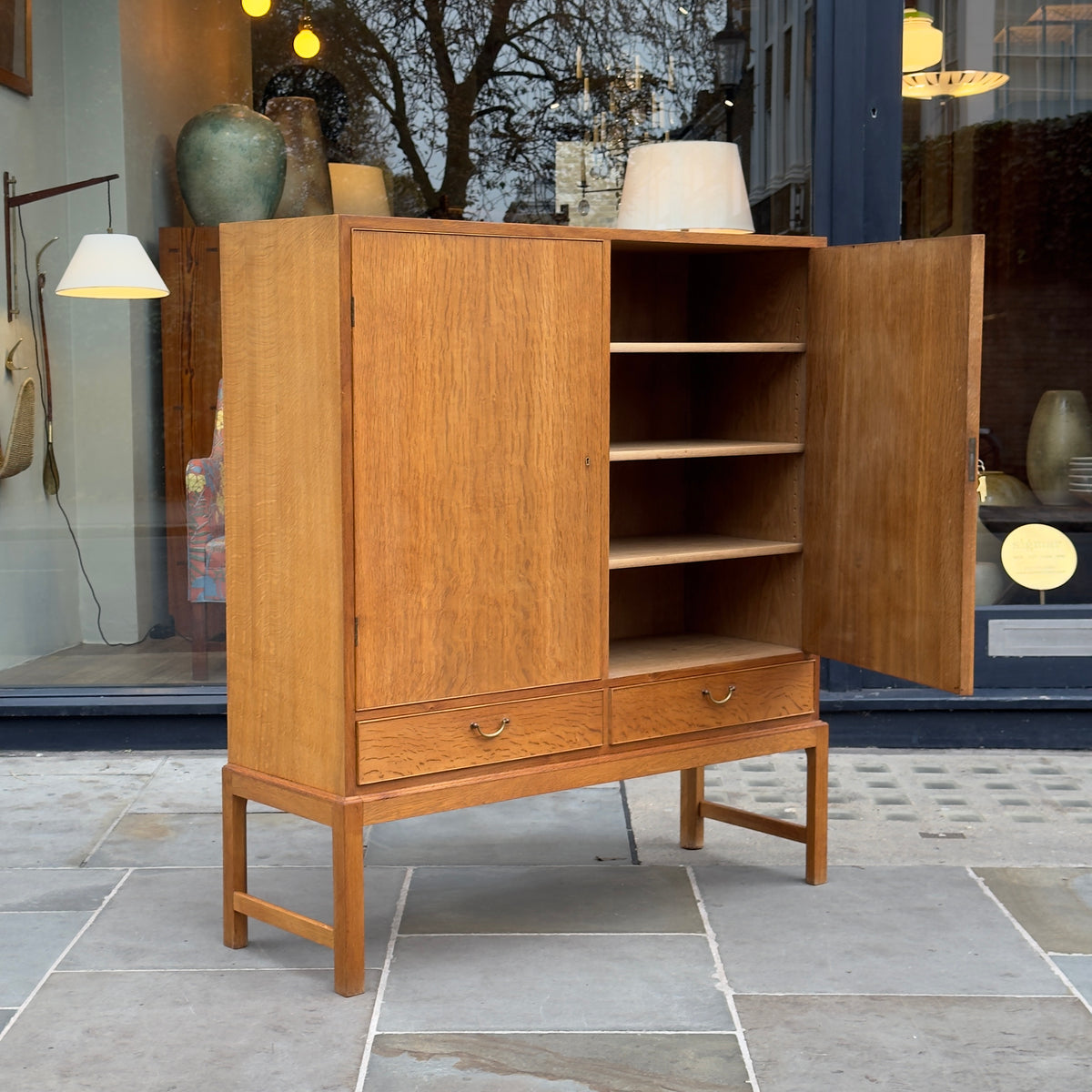A tall oak cabinet designed by Ole Wanscher and crafted by A.J. Iversen in Denmark. This midcentury piece exemplifies Danish modern design with its refined craftsmanship and timeless elegance.