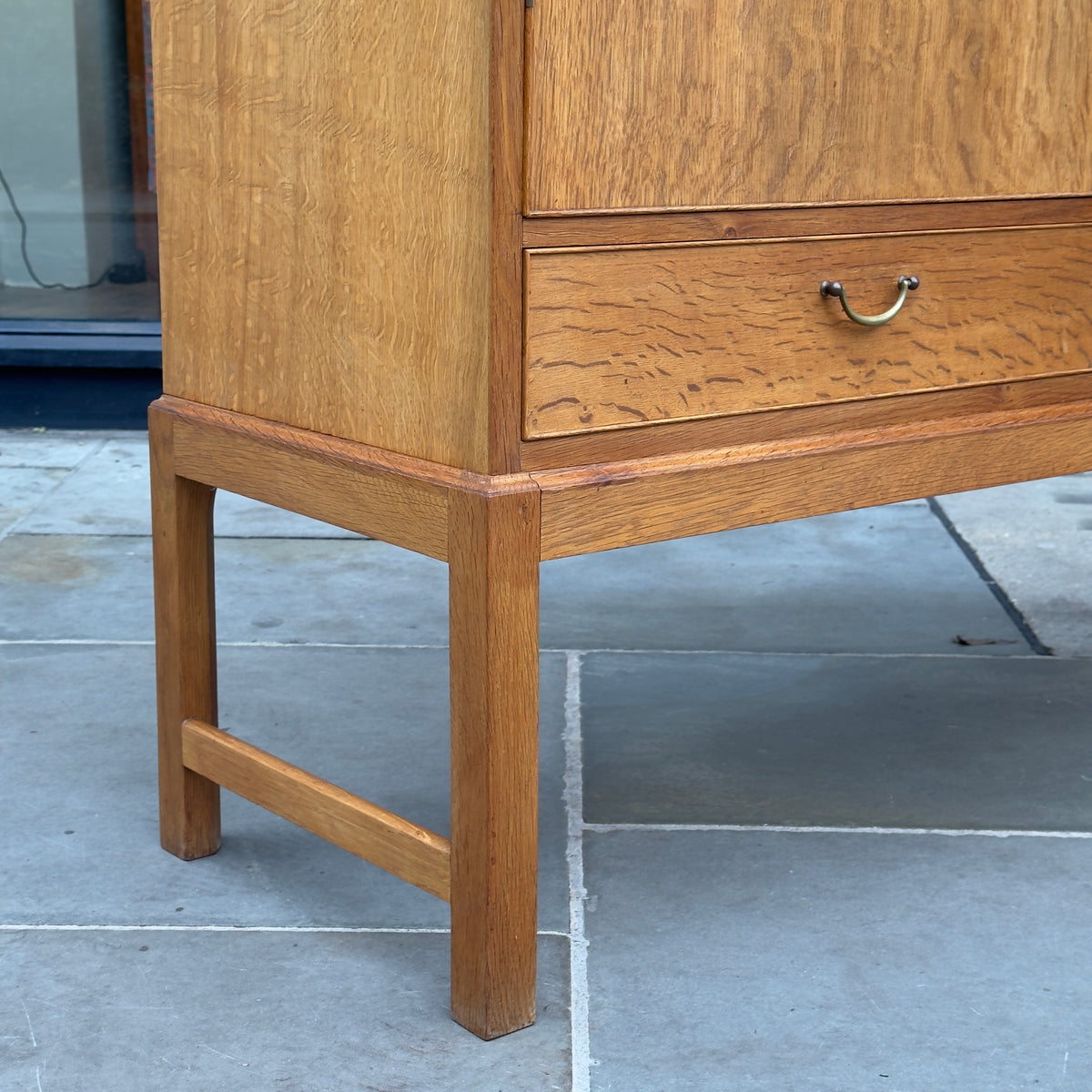 A tall oak cabinet designed by Ole Wanscher and crafted by A.J. Iversen in Denmark. This midcentury piece exemplifies Danish modern design with its refined craftsmanship and timeless elegance.