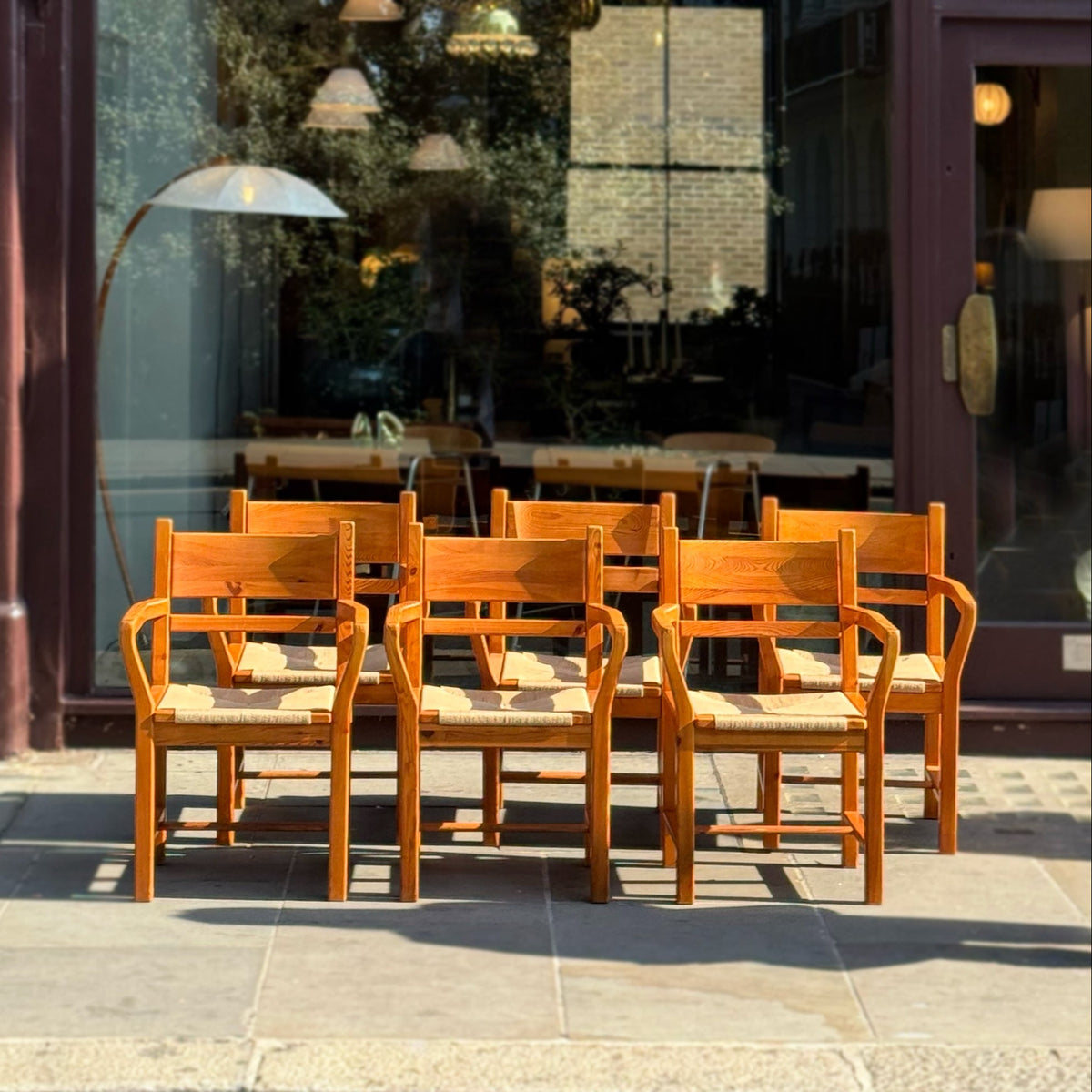 A set of 6 danish pine dining chairs with paper cord seats, pictured outside antiques dealership, Sigmar. 