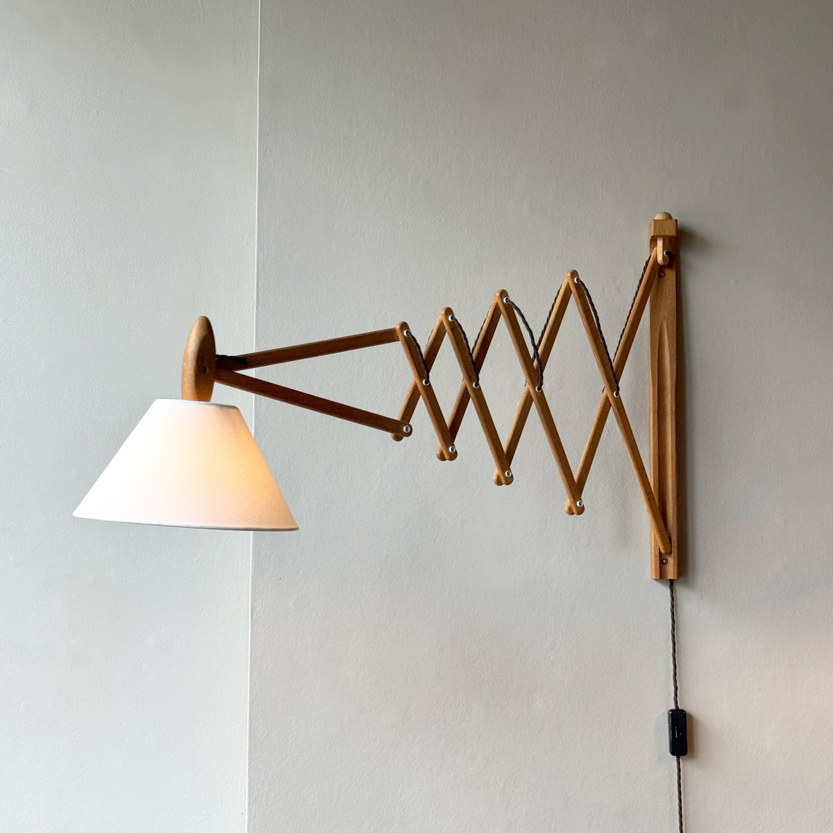 A wooden 'Sax' (scissor) wall lamp designed by Erik Hansen for Le Klint, Denmark, 1952.