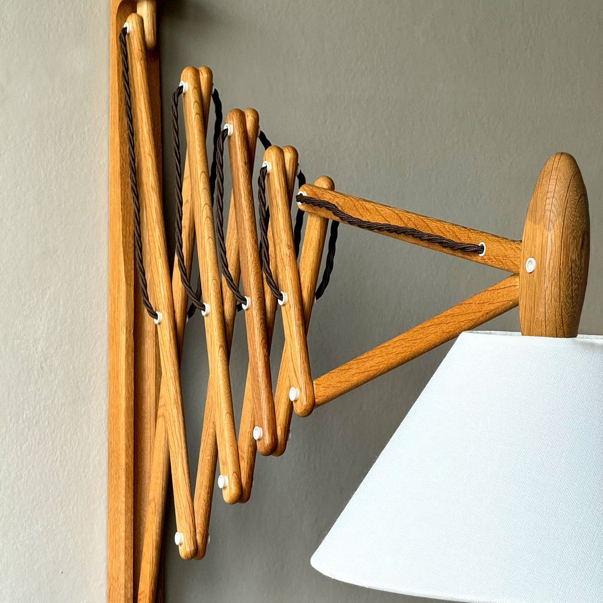 A wooden 'Sax' (scissor) wall lamp designed by Erik Hansen for Le Klint, Denmark, 1952.