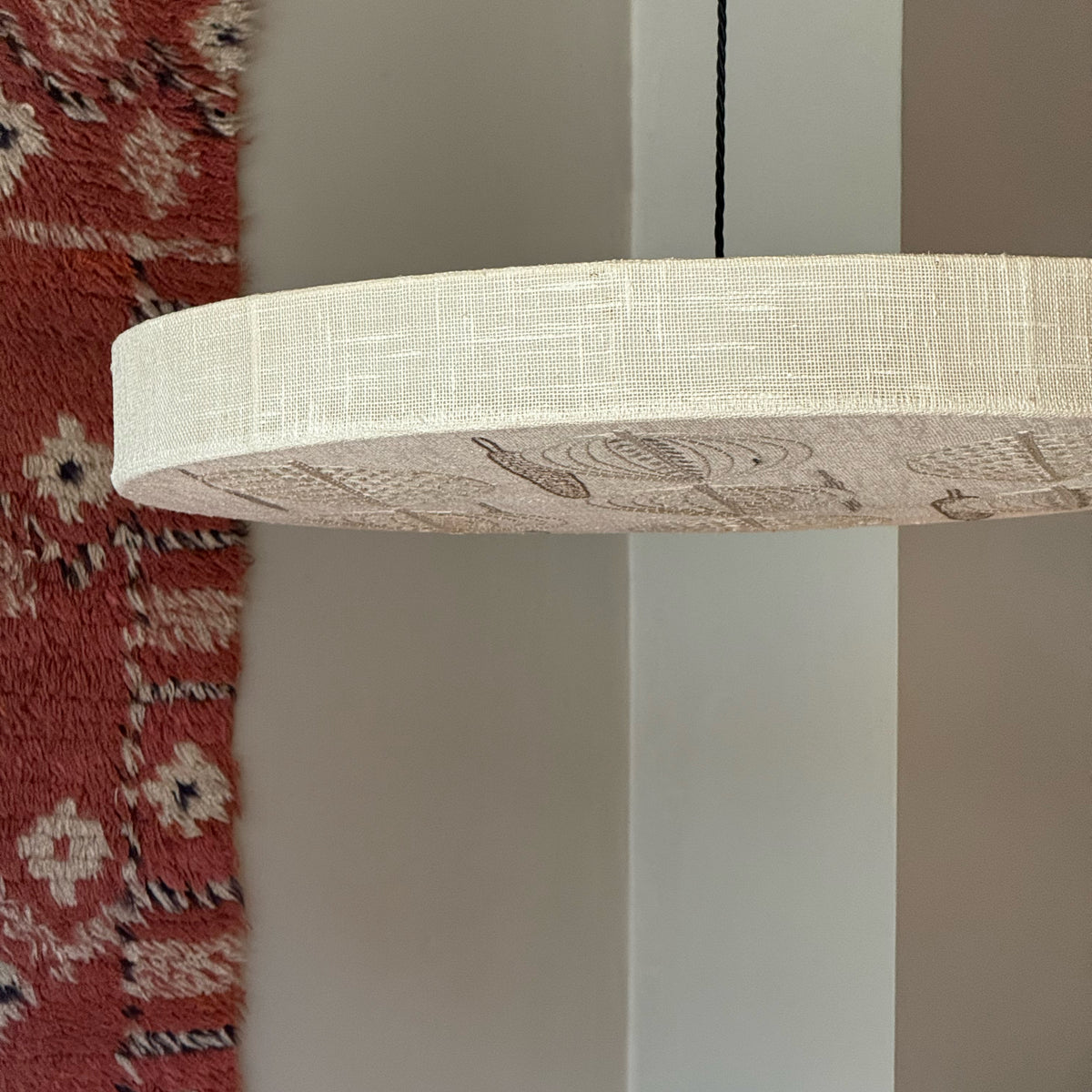 Sigmar London. Designed in the 1970s, the lamp emits a soft, diffused light through delicate stitched patterns, blending textile craftsmanship with functional lighting, from Sweden.