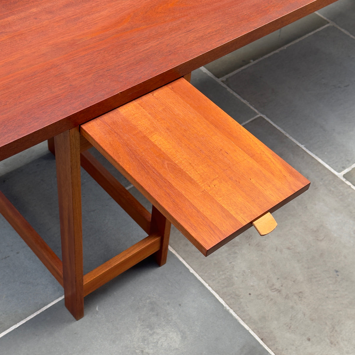 A long, narrow table designed by Sigurd Højland Olsen, made of mahogany and featuring a pull-out drawer. This piece showcases functional elegance and classic craftsmanship.