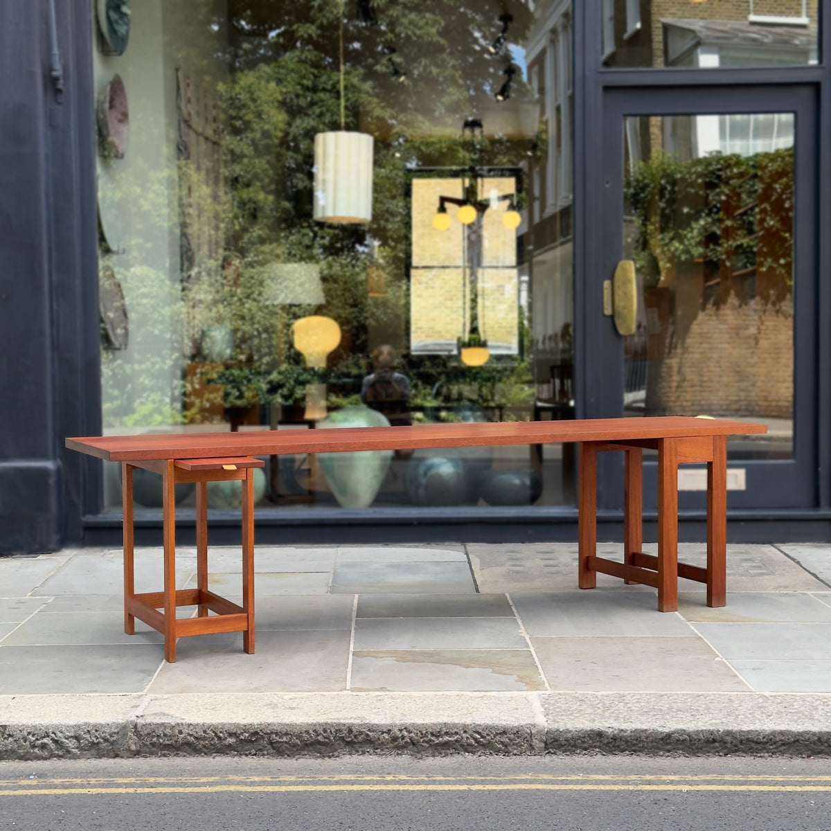 A long, narrow table designed by Sigurd Højland Olsen, made of mahogany and featuring a pull-out drawer. This piece showcases functional elegance and classic craftsmanship.
