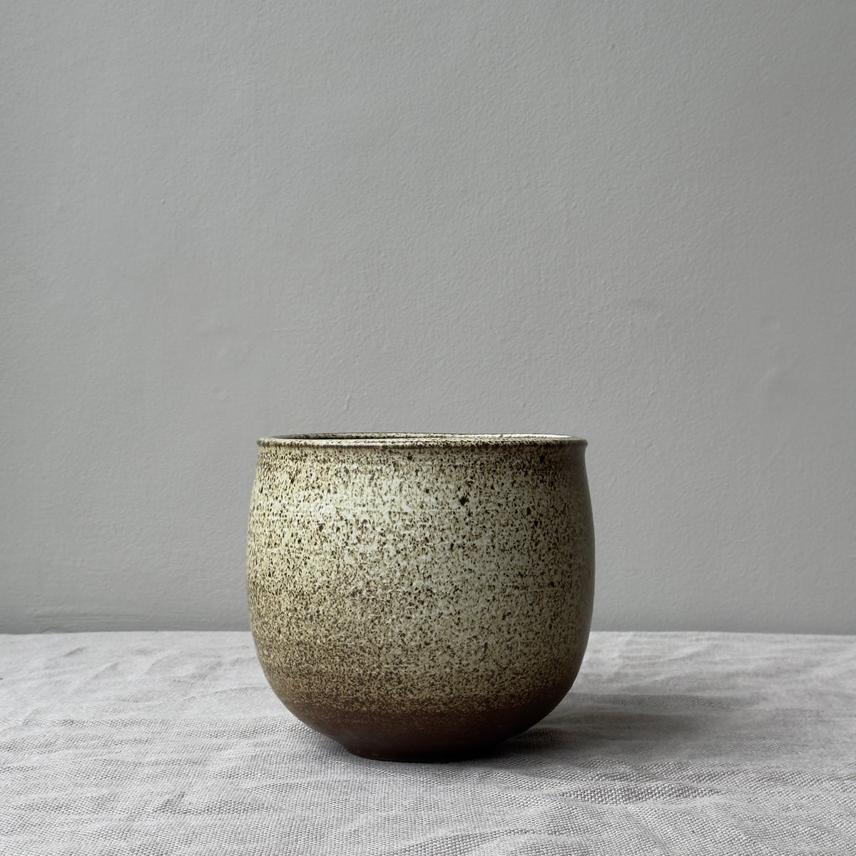 A stoneware planter by K.H. Würtz, featuring a white and brown glaze. This piece showcases the artisanal craftsmanship and simple elegance characteristic of Würtz's work.