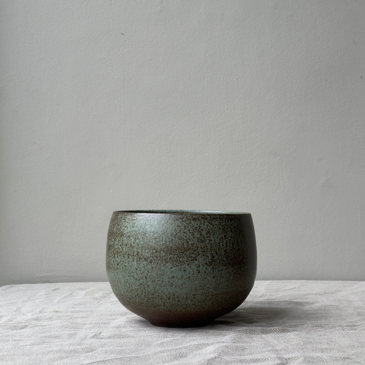 A stoneware planter by K.H. Würtz, featuring a white and brown glaze. This piece showcases the artisanal craftsmanship and simple elegance characteristic of Würtz's work.