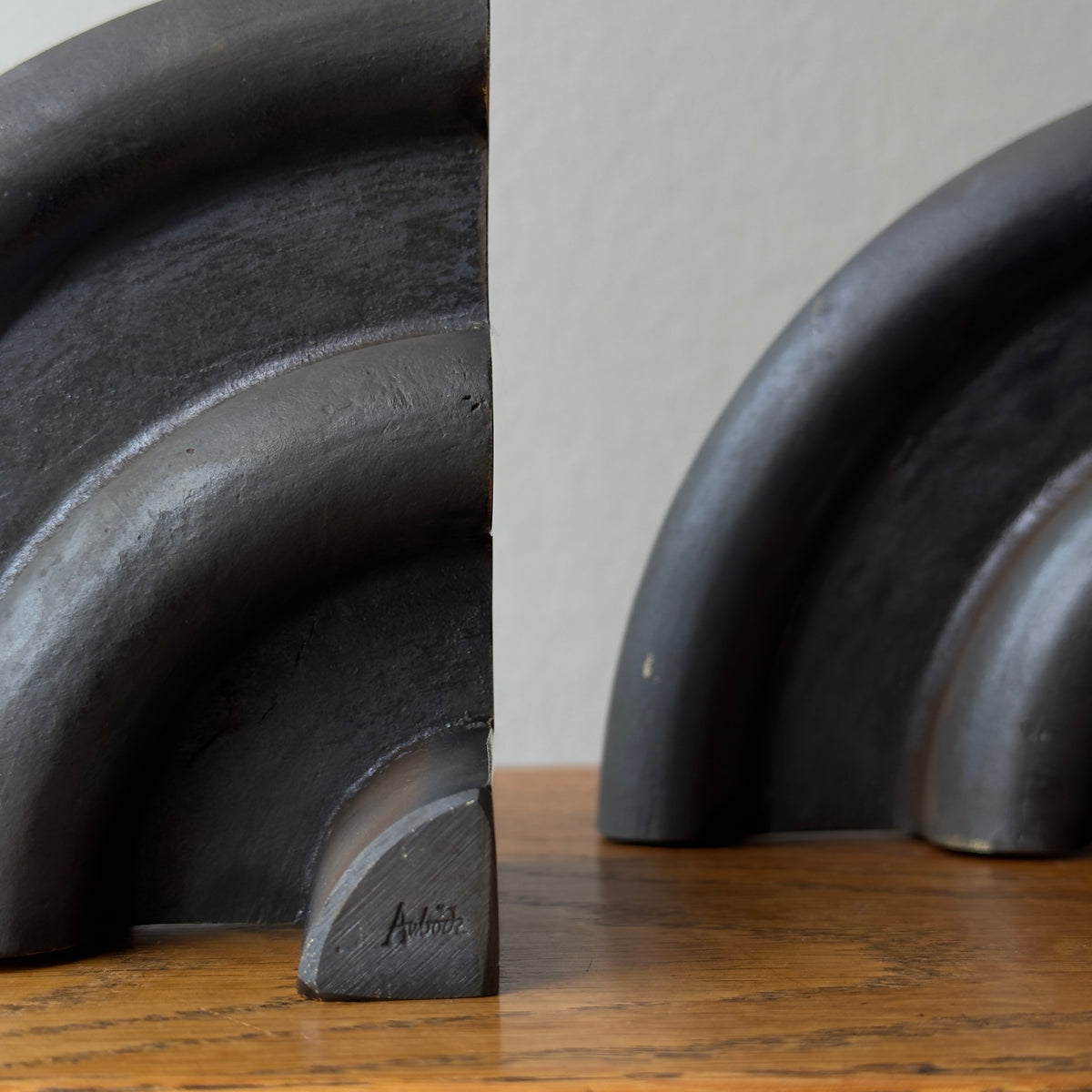 A cast brass bookend named 'Sun,' model 5533, designed by Carl Auböck and made in Vienna. This piece exemplifies modernist design with its sleek and artistic form.