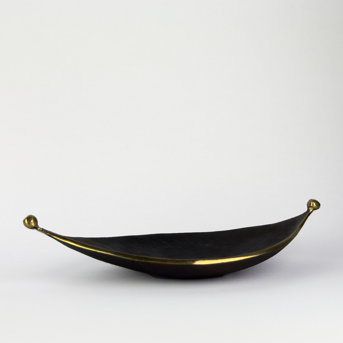 A midcentury leaf tray by Carl Auböck, available at Sigmar London. Crafted in brass with a textured finish, this versatile piece serves as an ashtray or decorative tray, exemplifying modern design and fine Austrian craftsmanship.