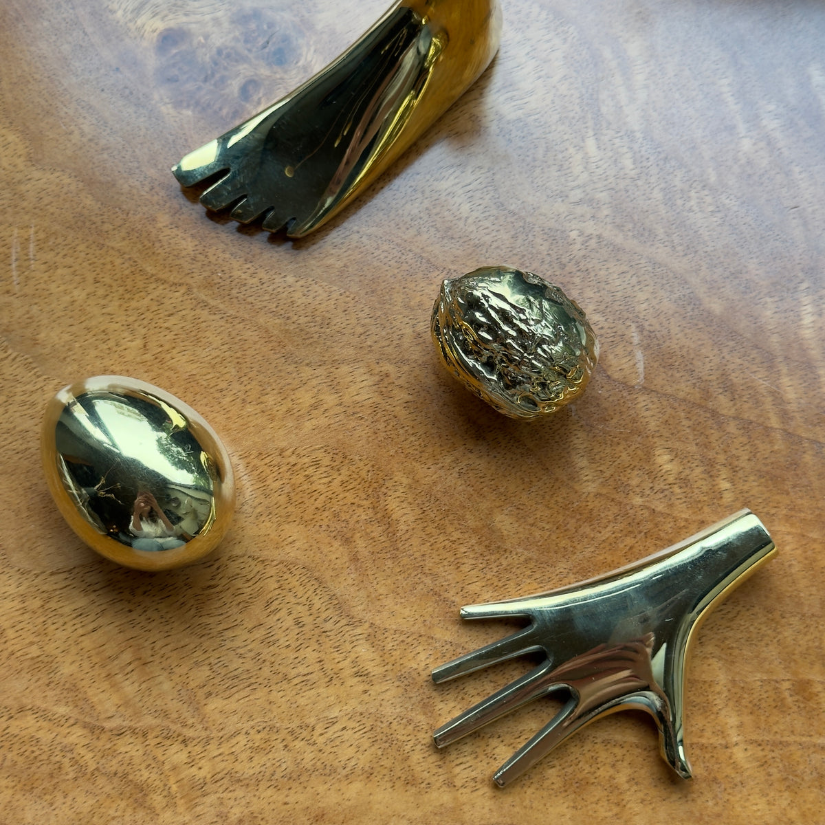 Brass paperweights by the Carl Aubock workshop, Vienna. Hand, walnut, foot and hand shapes. 