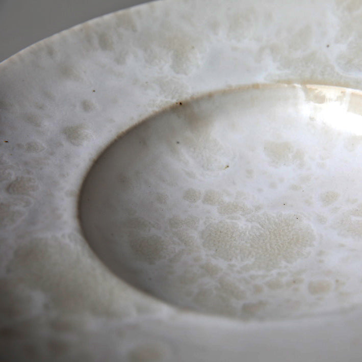 Large flat-out bowl by Kasper Würtz, featuring an ivory ‘Shape 11’ glaze. Handcrafted with Würtz’s signature Nordic craftsmanship, this elegant ceramic piece showcases a soft, refined design. Available at Sigmar London.